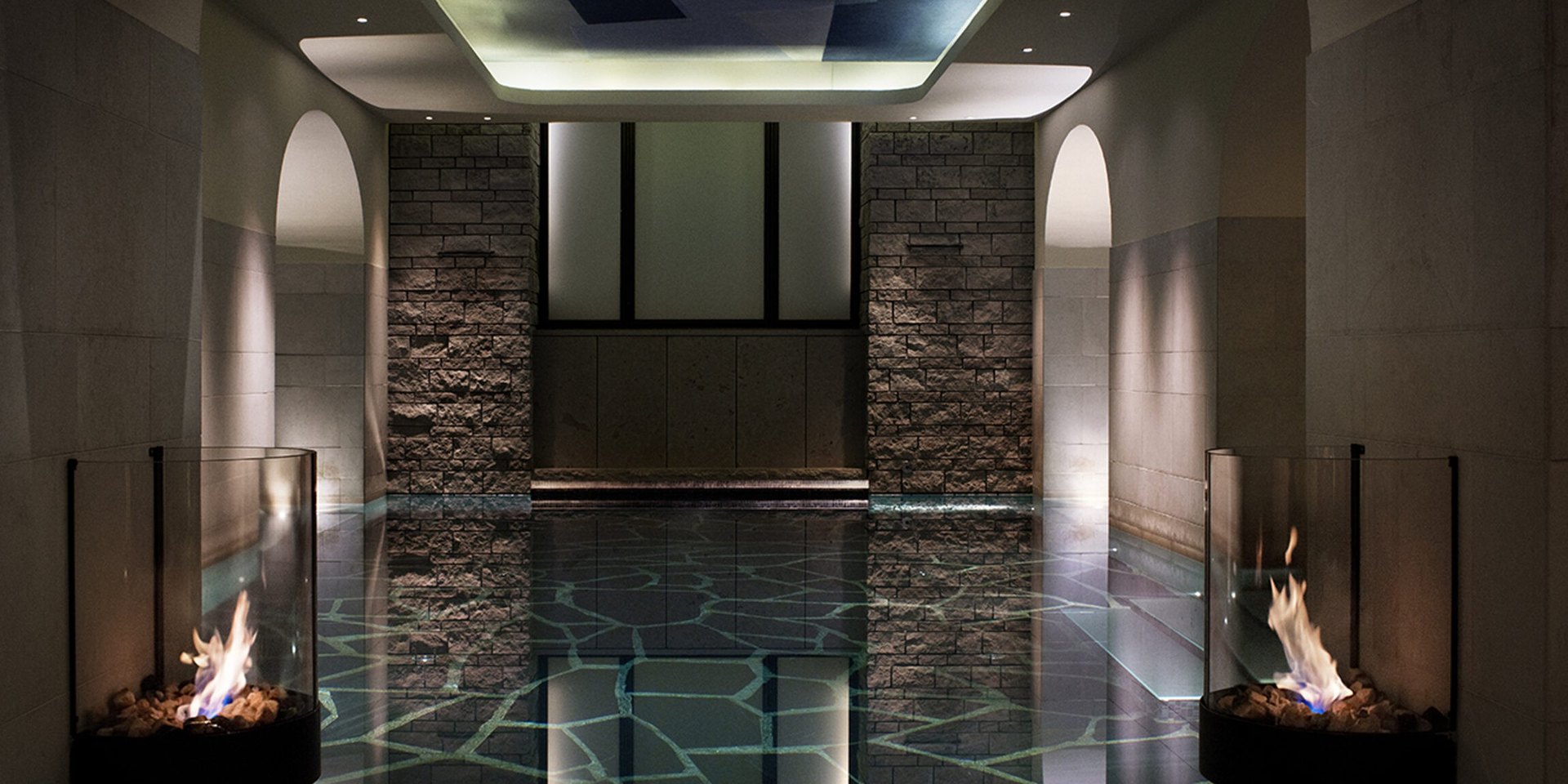 The spa at Lydmar Hotel: a candlelit pool between stone walls and two fires