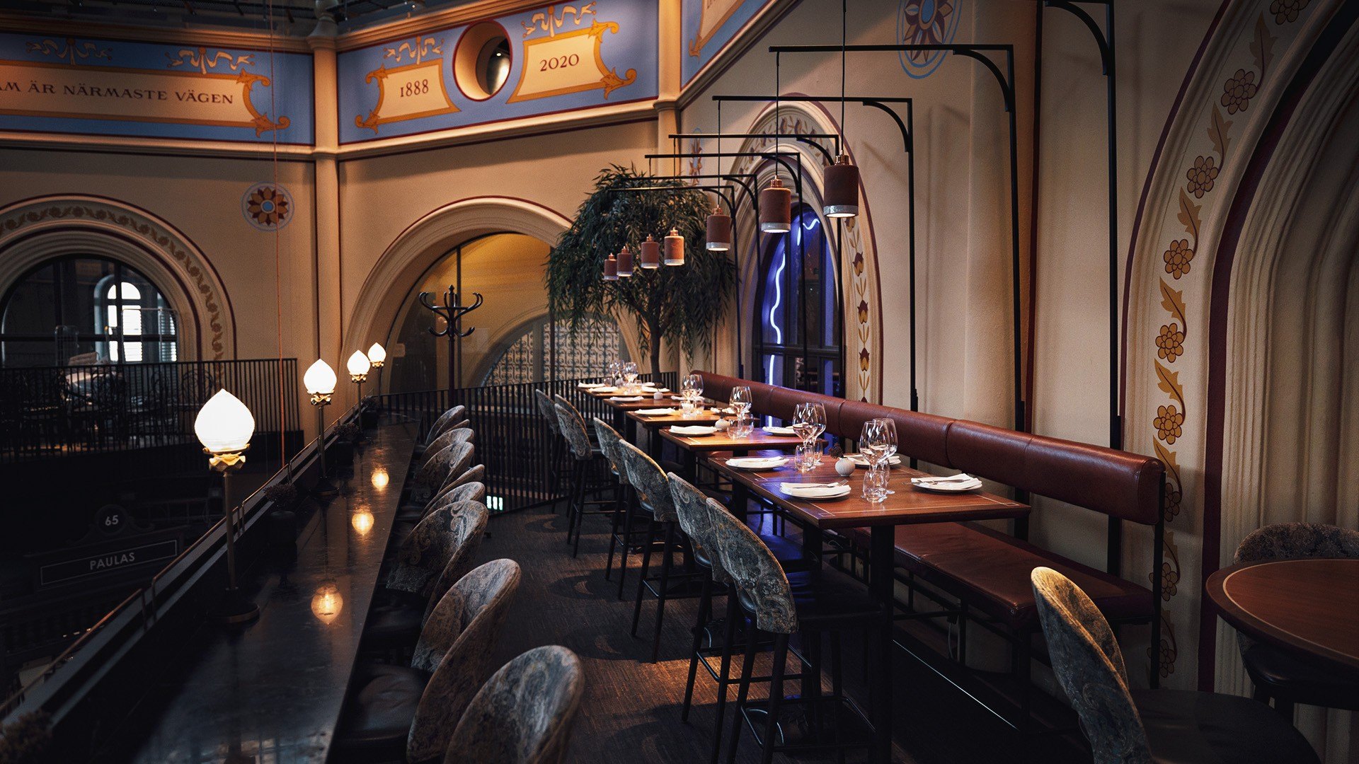 The gallery restaurant of Östermalms Saluhall, beneath painted arches marked 1888 and 2020