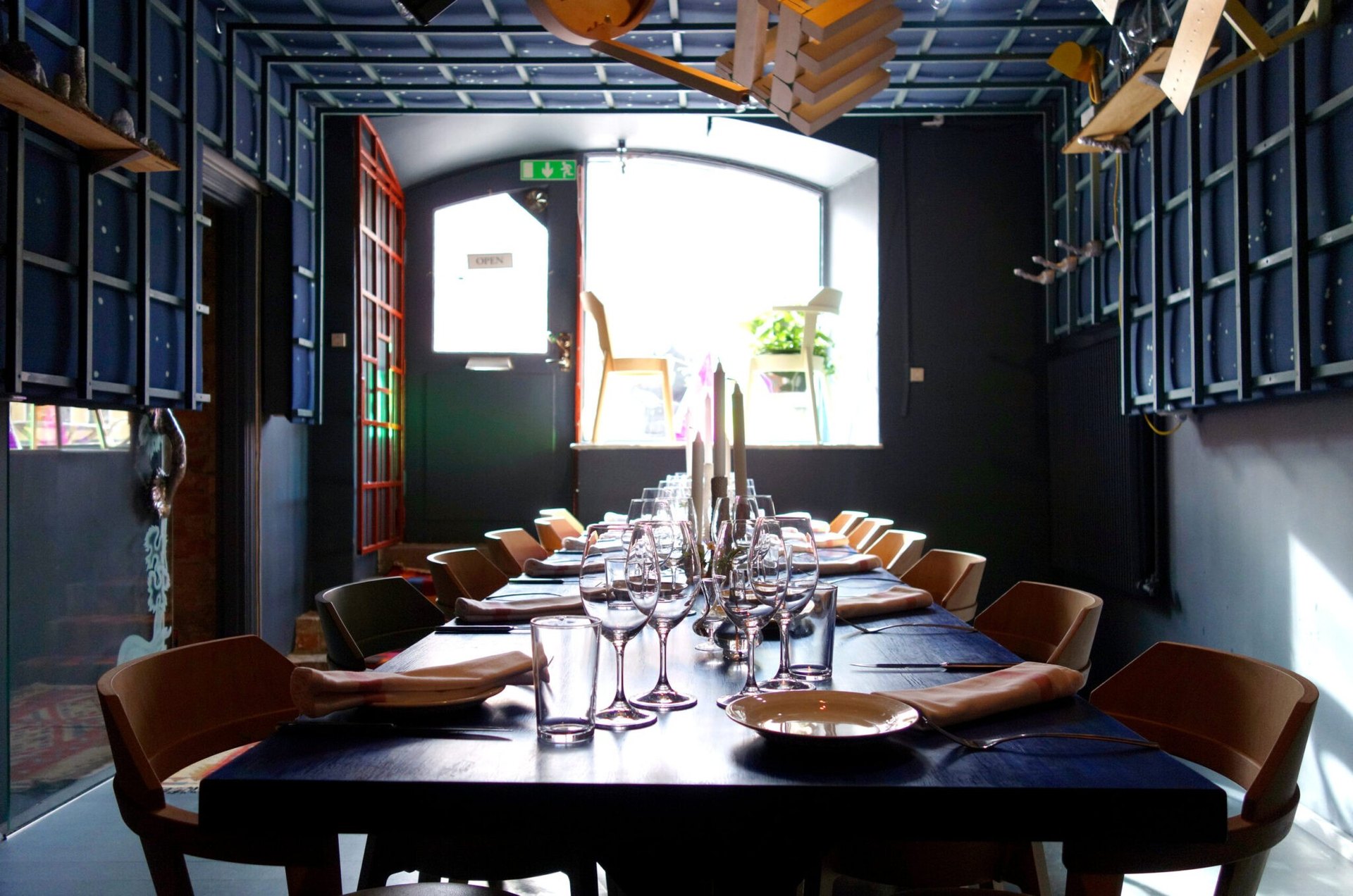 A long candlelit table set for dinner at Woodstockholm
