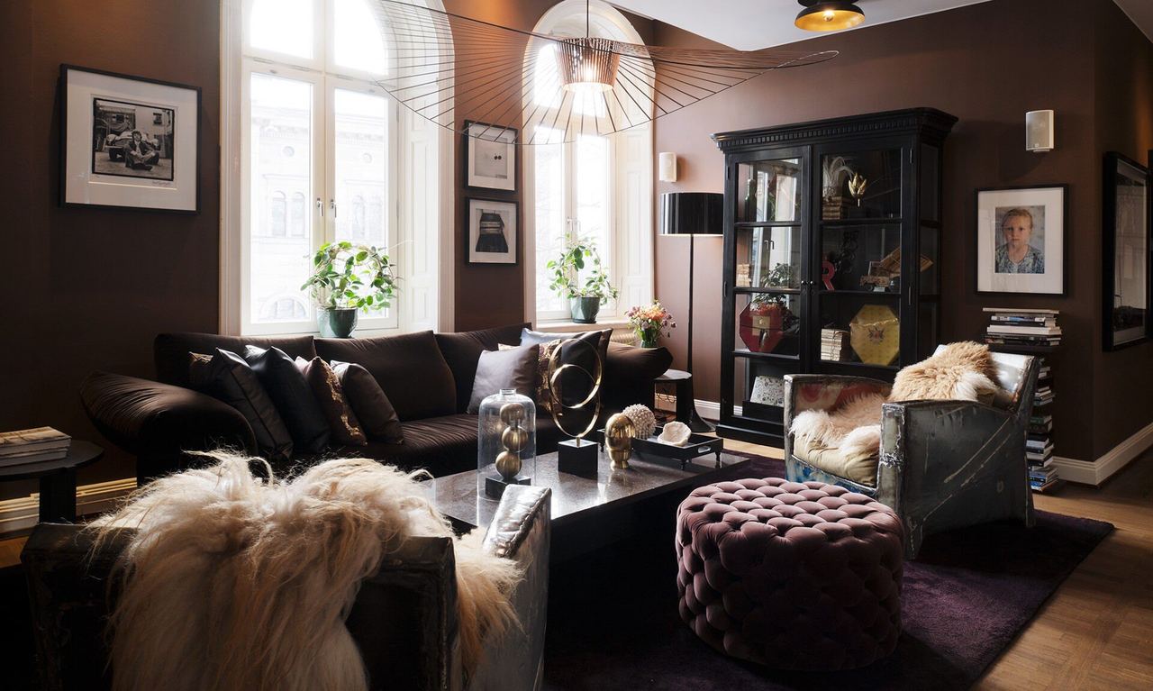 A lounge at Lydmar Hotel, with sheepskins, velvet and photographs on dark walls