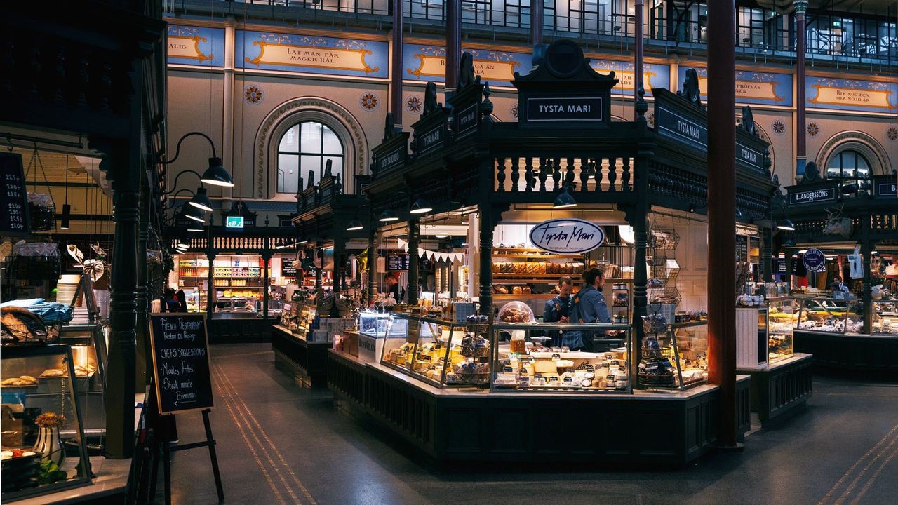 Inside Östermalms Saluhall: the market stalls under the hall’s painted arches